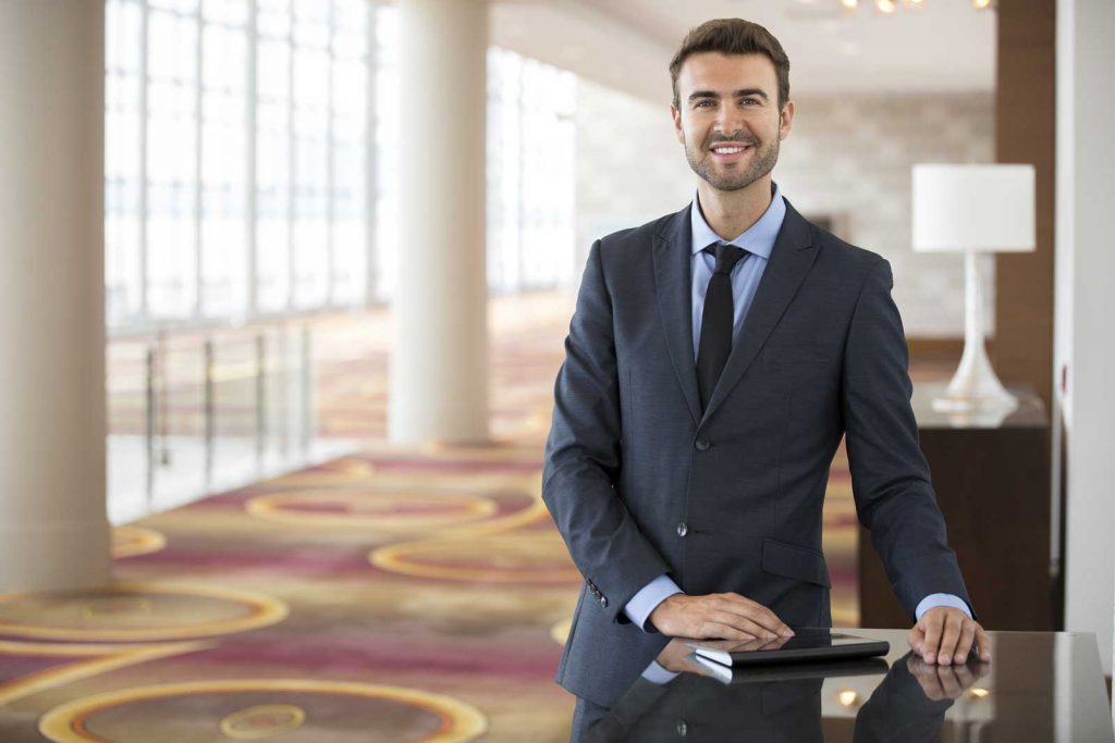 Man standing at the entry of hotel lobby